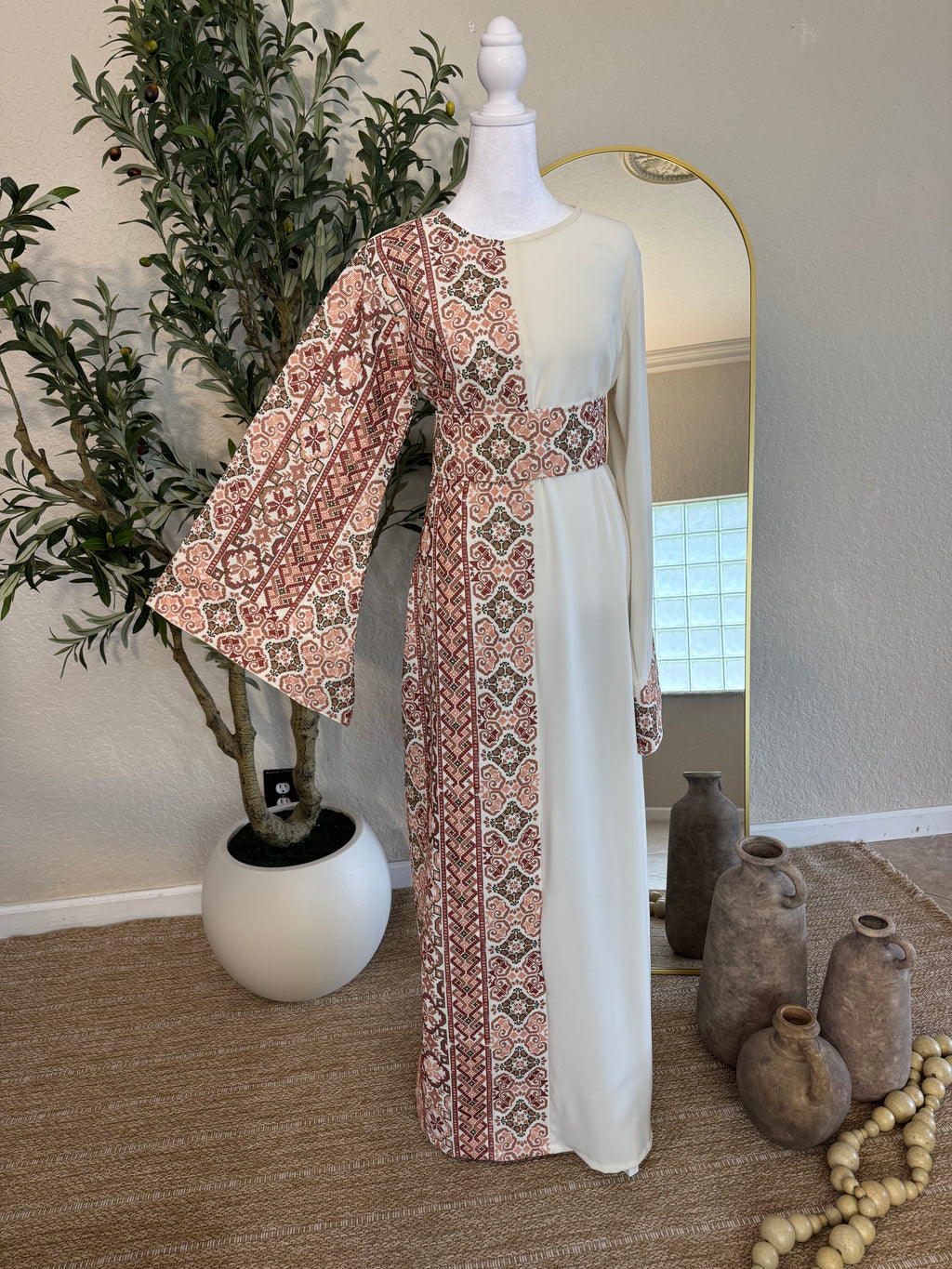 Elegant "The Rosewater Thoub" featuring intricate Palestinian embroidery on one side with a flowing, modest silhouette and wide sleeves, perfect for luxury modest fashion.