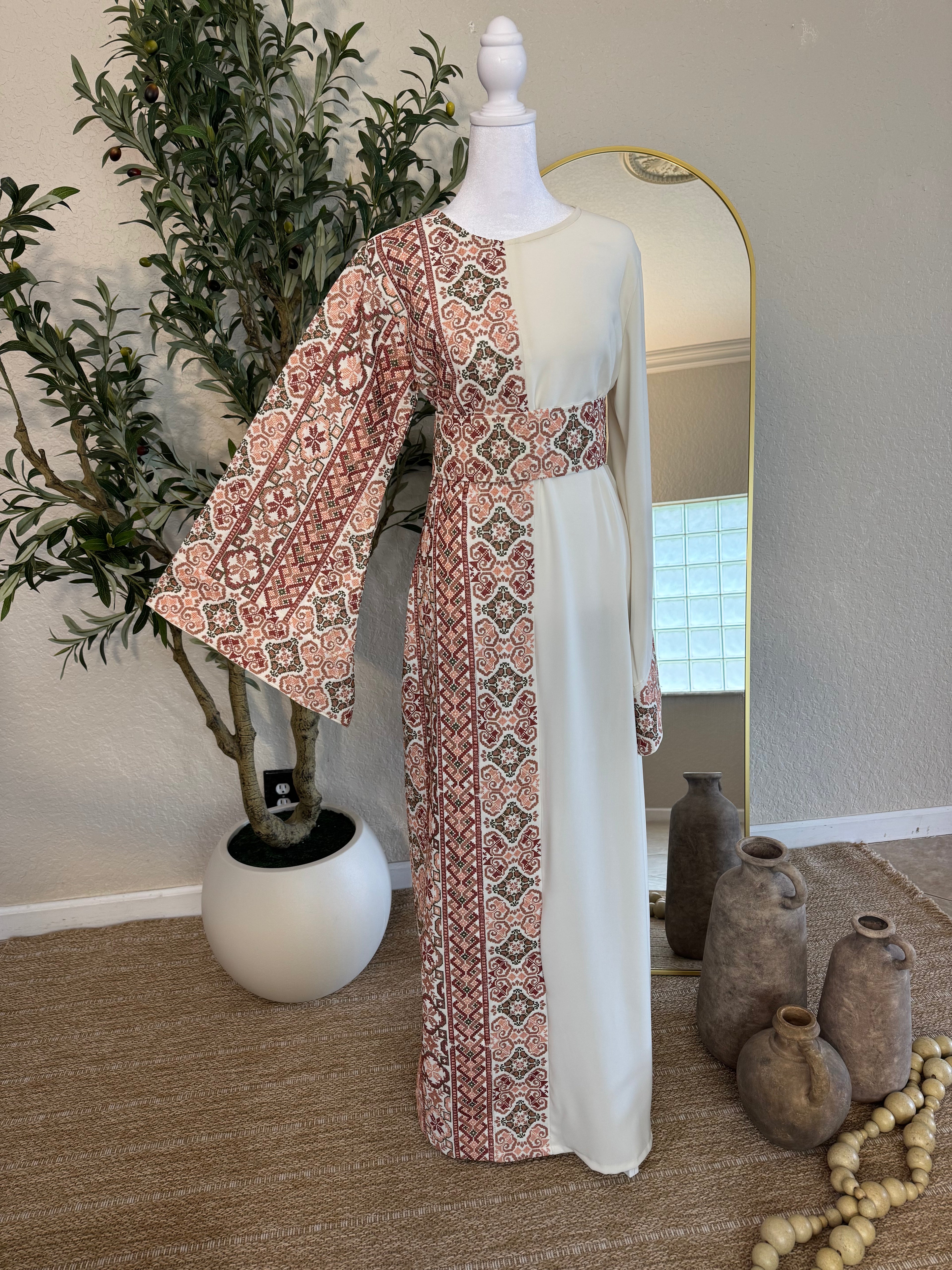 Elegant "The Rosewater Thoub" featuring intricate Palestinian embroidery on one side with a flowing, modest silhouette and wide sleeves, perfect for luxury modest fashion.