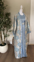 Front view of The Azure Bloom Palestinian Abaya with powder blue inner dress and silver blue floral outer layer