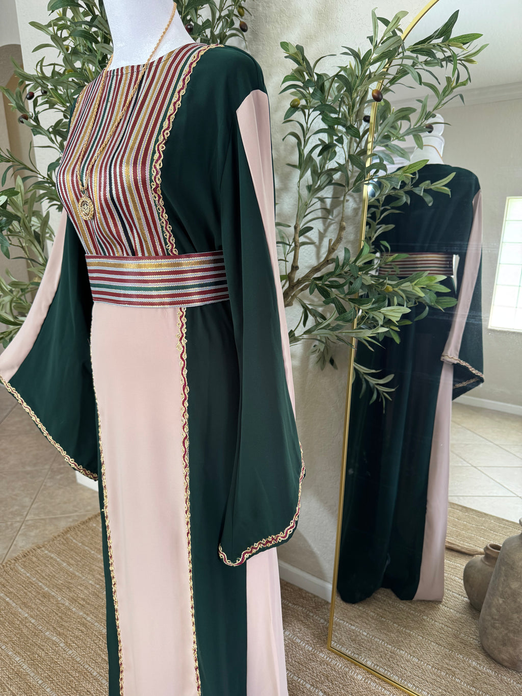 Side view of The Cedar Rose Thoub showcasing flowing modest silhouette and intricate Palestinian-inspired embroidery