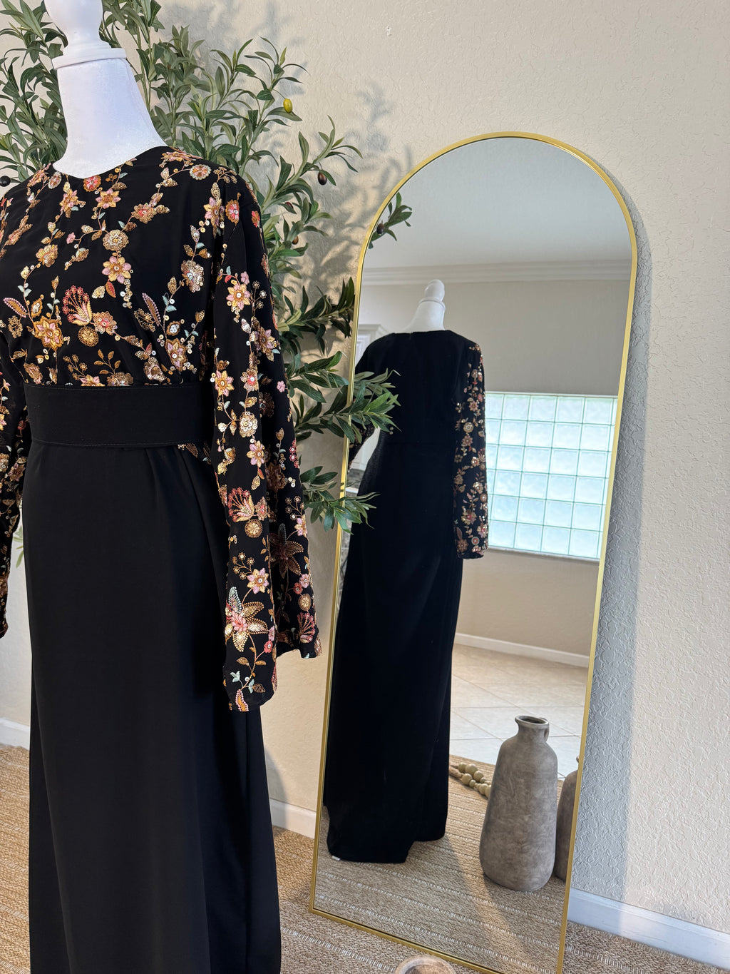 Black evening dress with romantic floral accents and wide sleeves