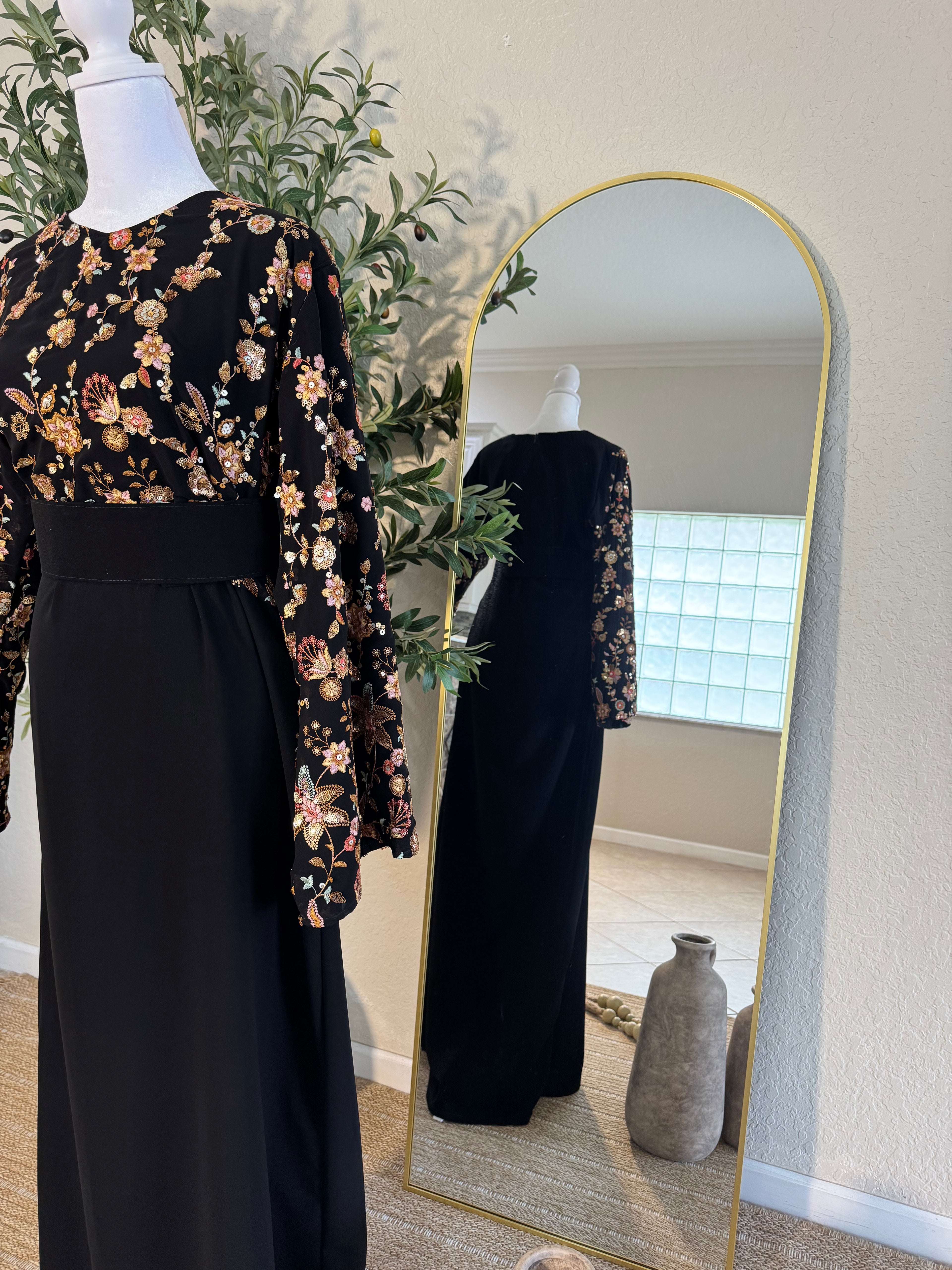 Black evening dress with romantic floral accents and wide sleeves