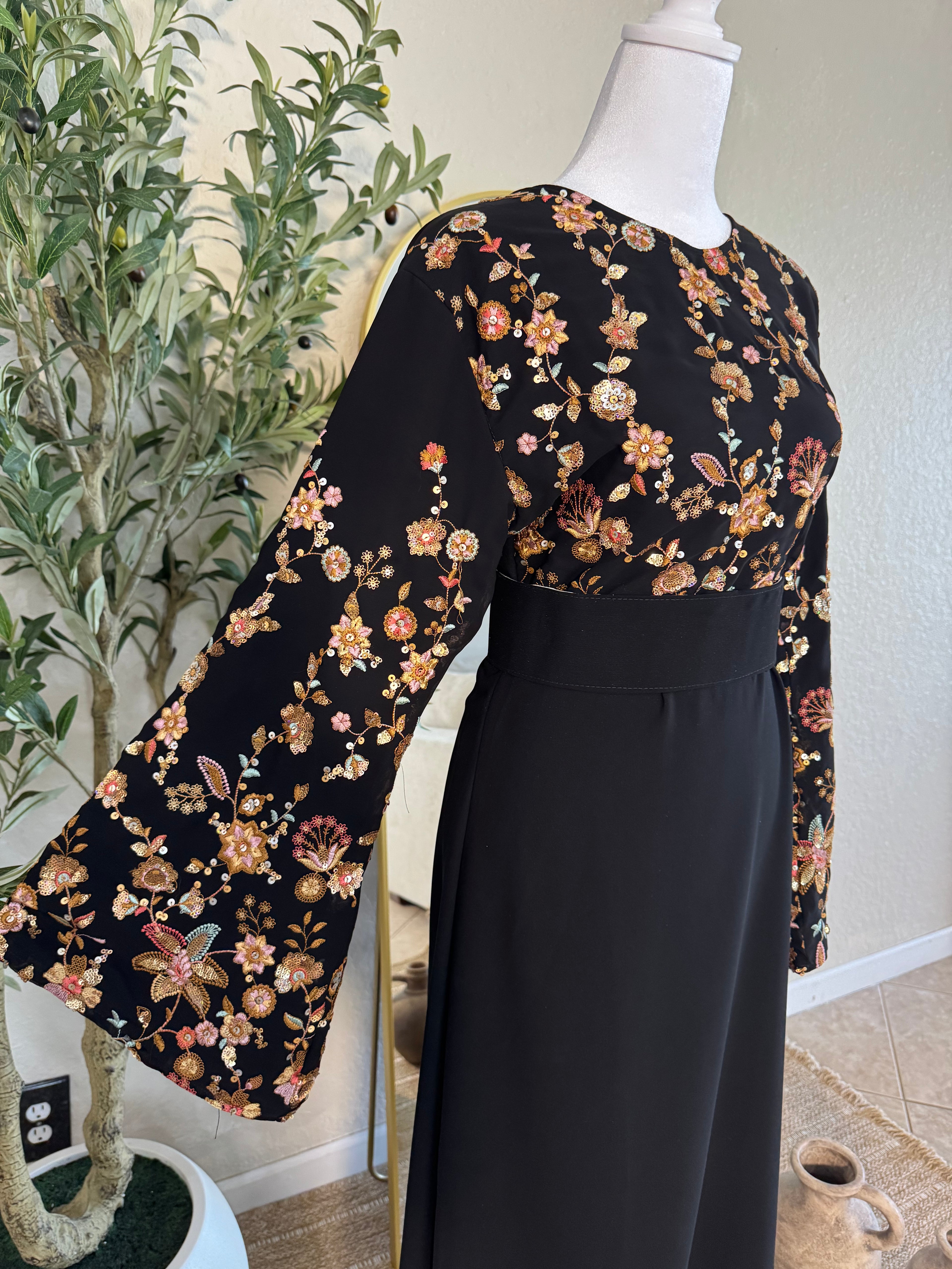 Luxury black dress with delicate floral detailing and fitted waistline