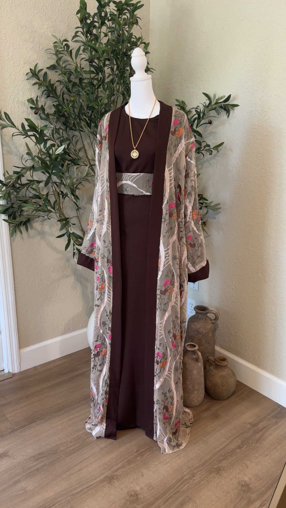 Front view of Hebron Rose Palestinian abaya with sheer floral embroidery and chocolate brown dress, made in Palestine