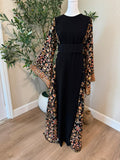 Jenin Garden black Palestinian thobe with colorful floral detailing, made in Palestine