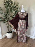 Front view of The Jericho Bloom Abaya featuring taupe embroidered panels, chocolate brown fabric and matching waist belt