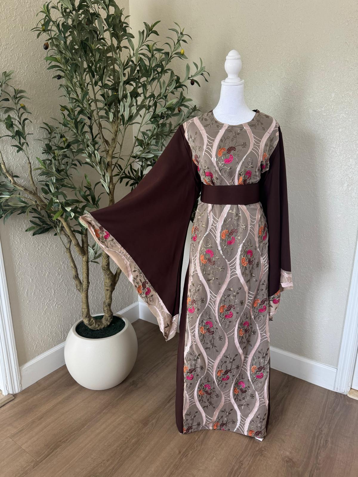 Front view of The Jericho Bloom Abaya featuring taupe embroidered panels, chocolate brown fabric and matching waist belt