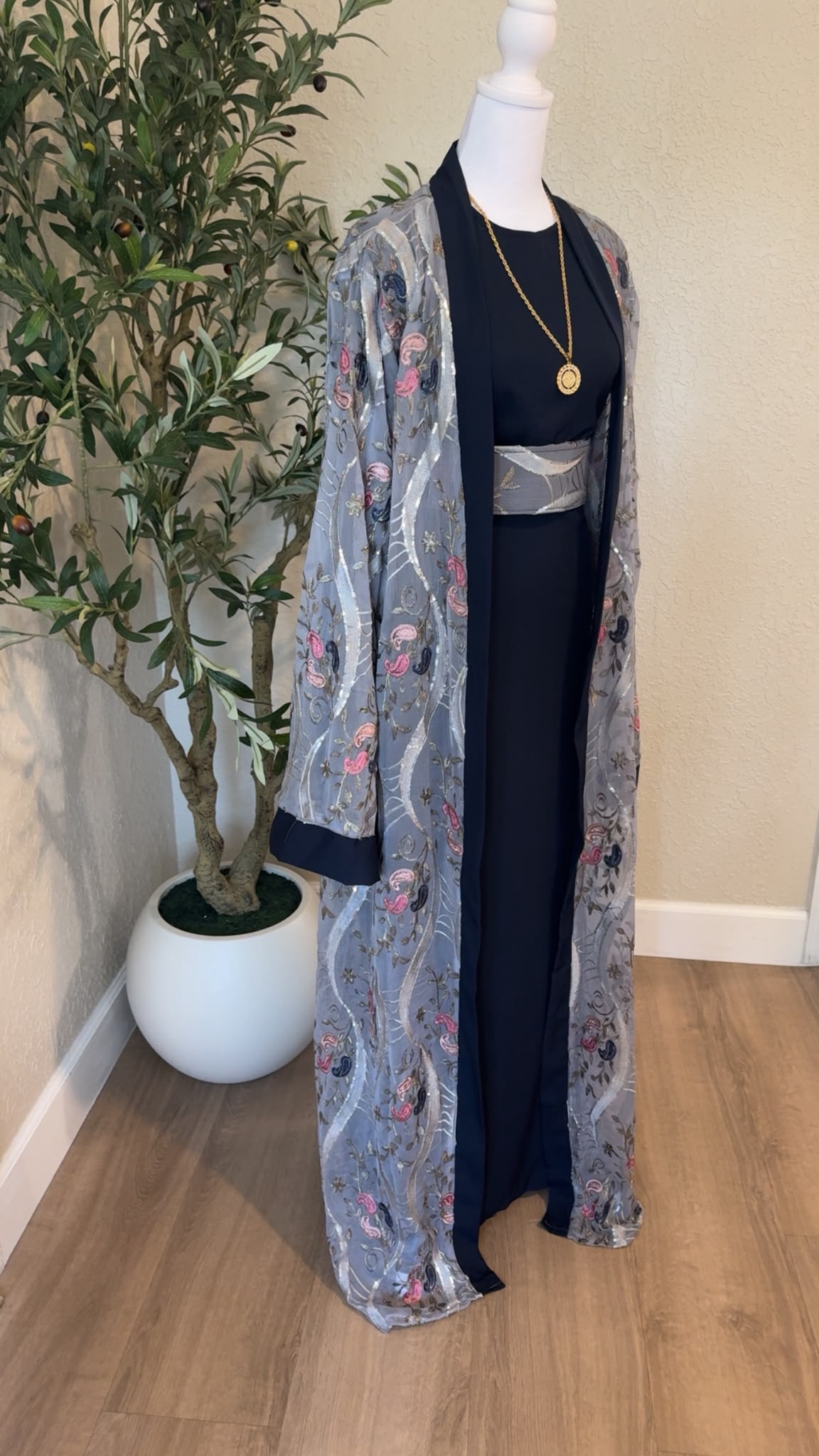 Side view of Nablus Night navy Palestinian abaya with gray embroidered overlay and coordinating belt, made in Palestine