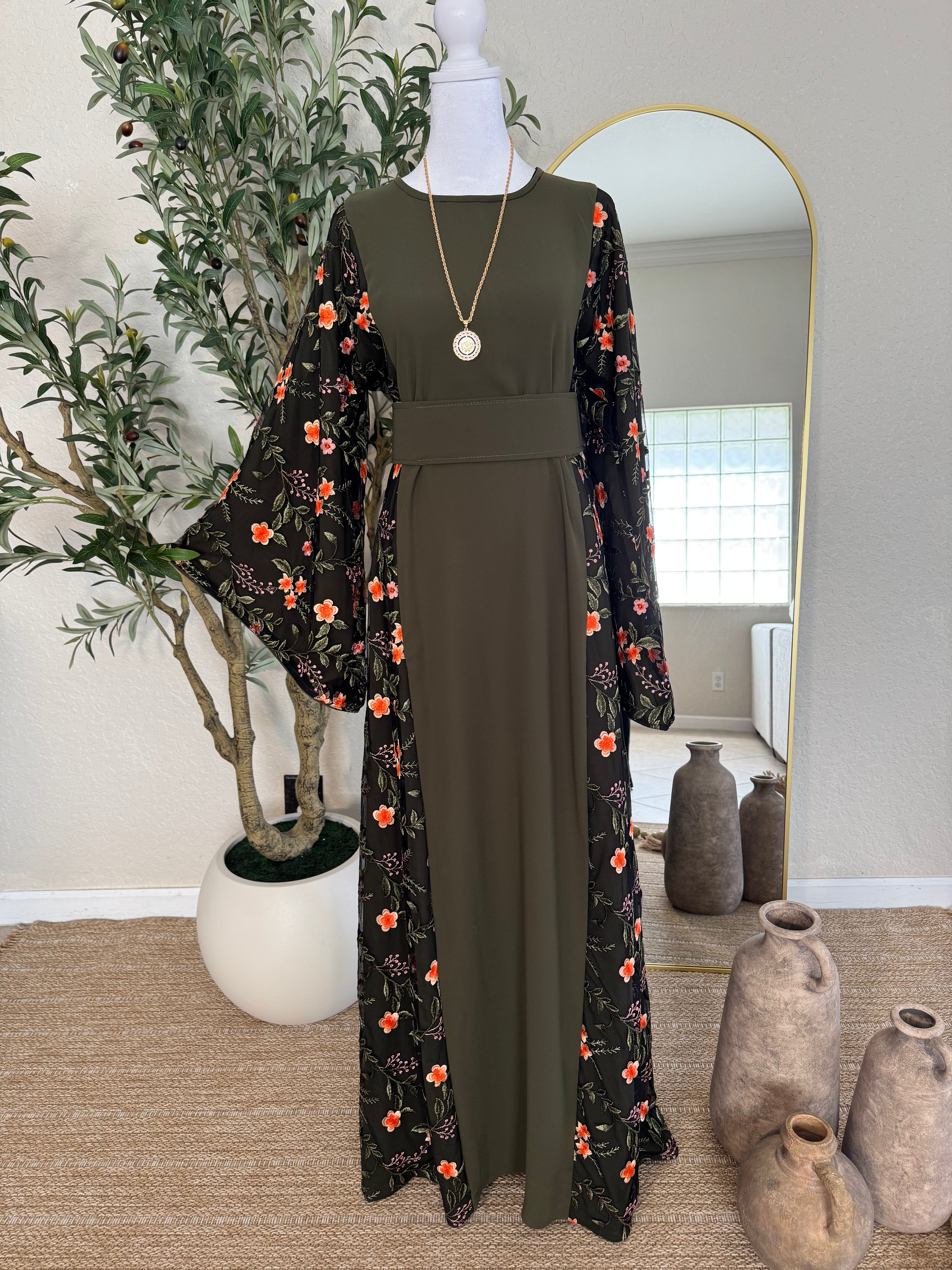 Luxury olive green modest dress with flowing floral sleeves and feminine silhouette