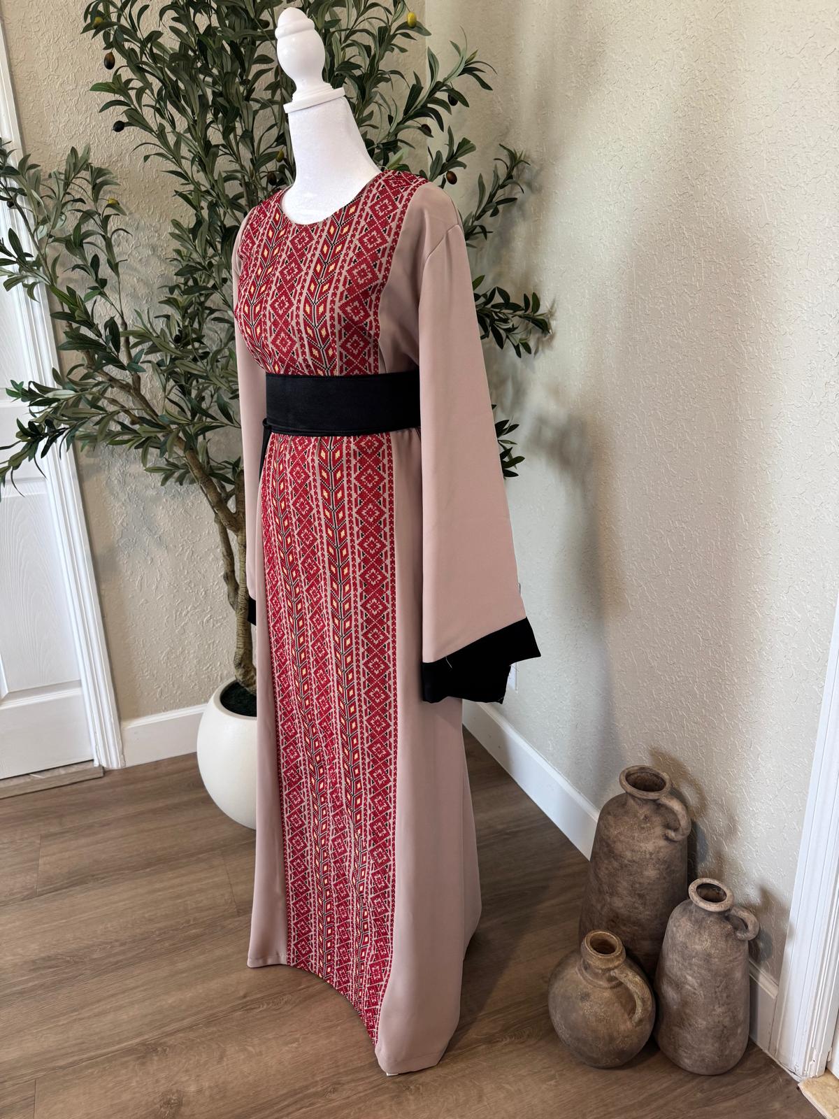Side view of The Ramallah Ruby Palestinian Abaya with full-length red patterned front panel and black trimmed flowing sleeves