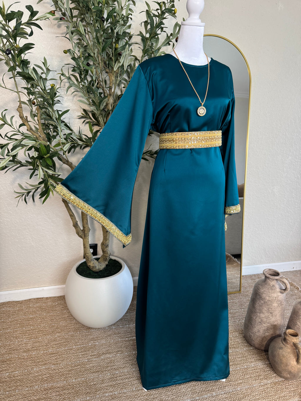 Elegant teal satin modest dress with gold detailing and flowing sleeves