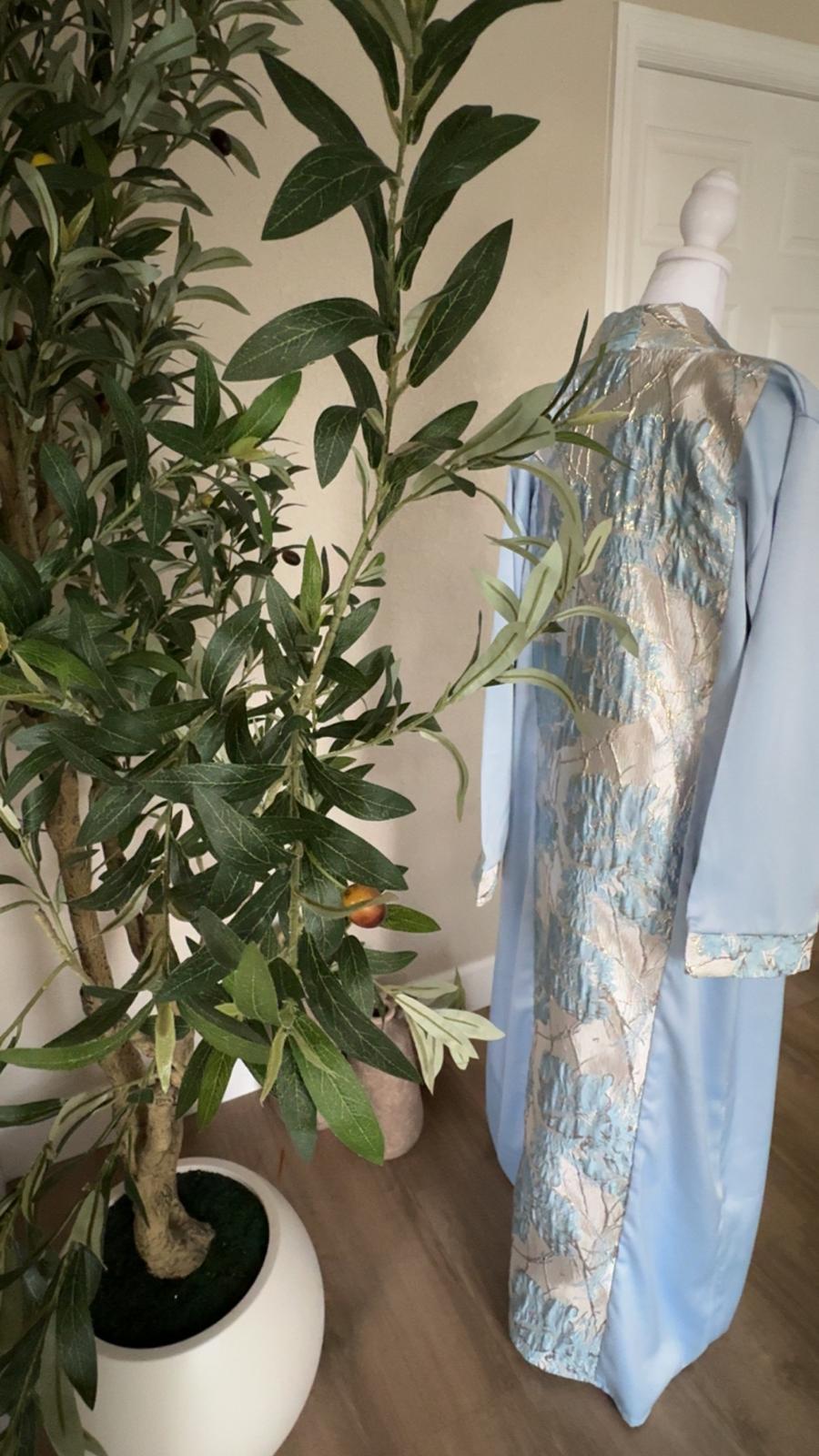 Back view of The Silver Sky Palestinian Abaya with metallic silver and blue floral center panel