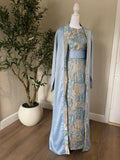 Front view of The Silver Sky Palestinian Abaya with powder blue outer layer and metallic floral center panel