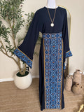 The Azraq Thoub navy modest dress with blue Palestinian inspired embroidery and flowing sleeves