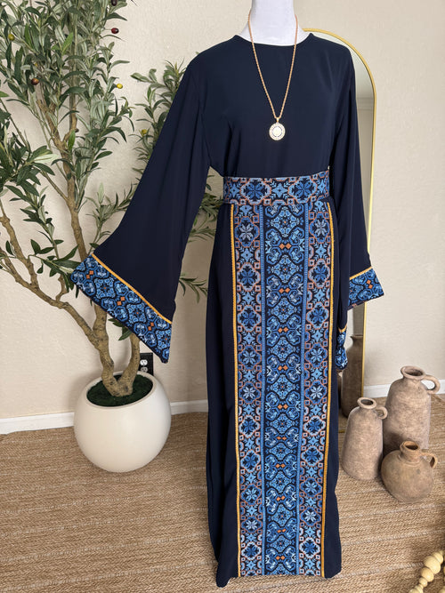 The Azraq Thoub navy modest dress with blue Palestinian inspired embroidery and flowing sleeves