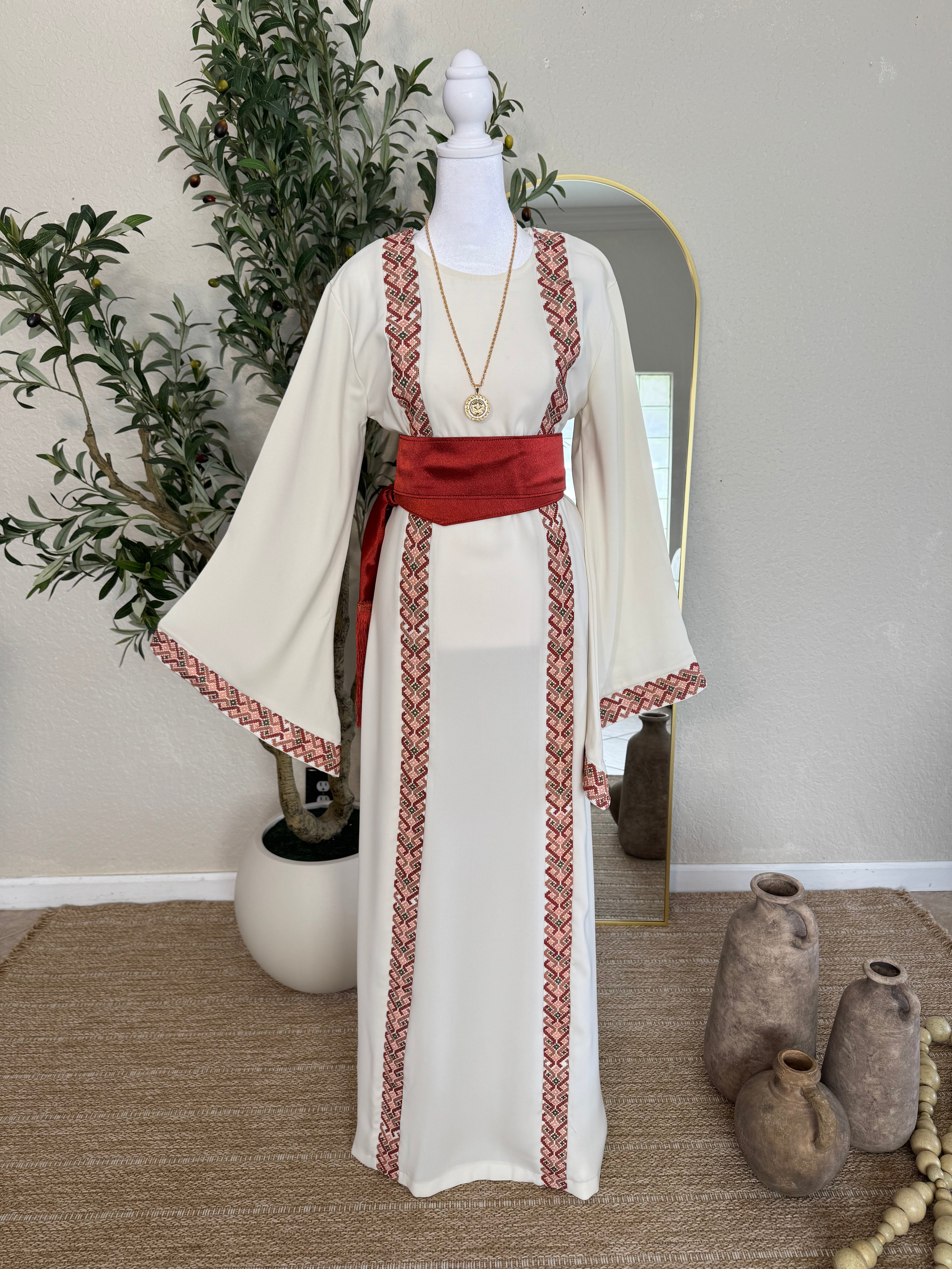 The Blush Heritage Thoub ivory modest dress with blush Palestinian inspired embroidery and flowing sleeves