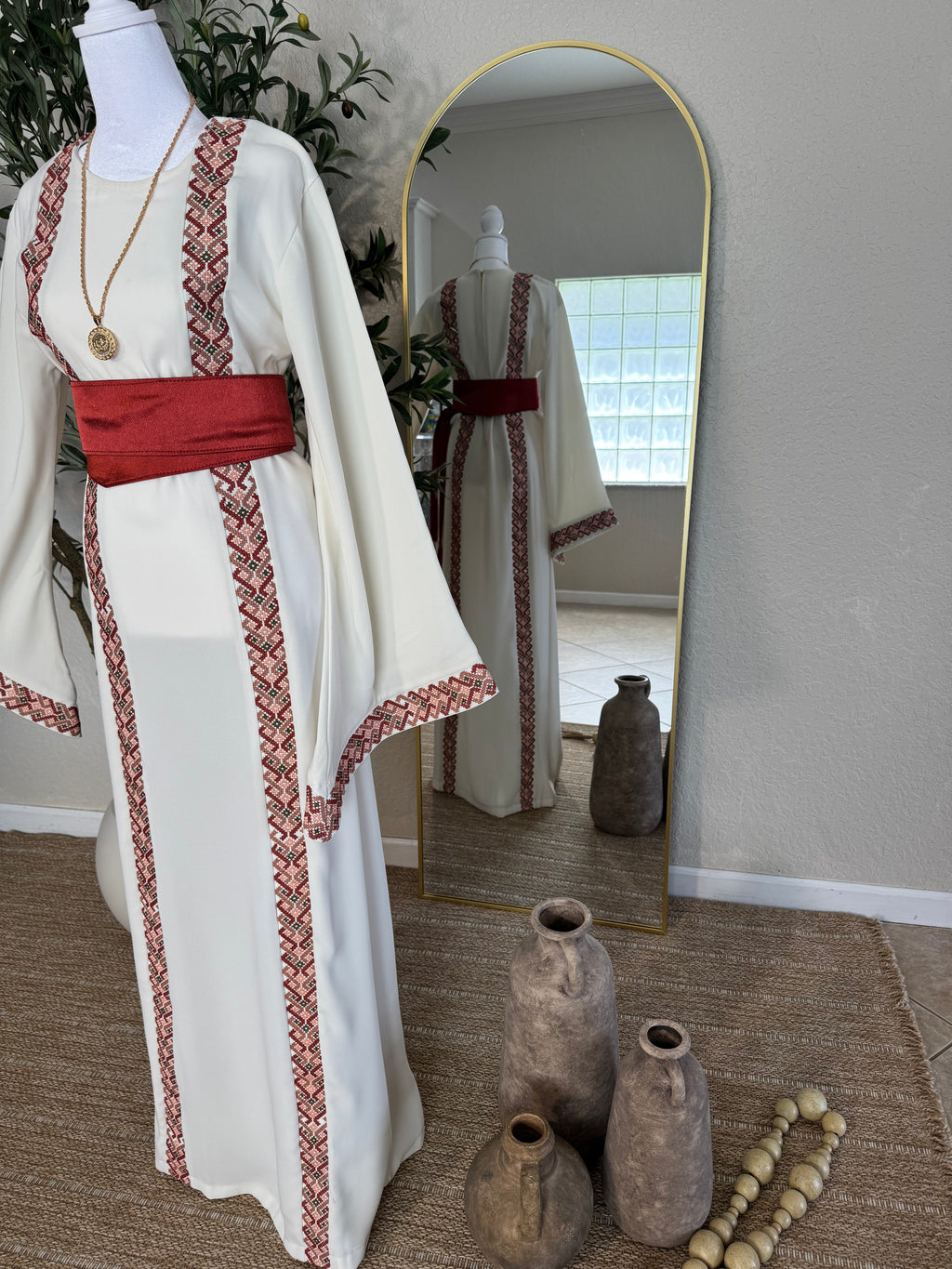 Luxury ivory thoub with embroidered front panels, satin sash, and elegant wide sleeves