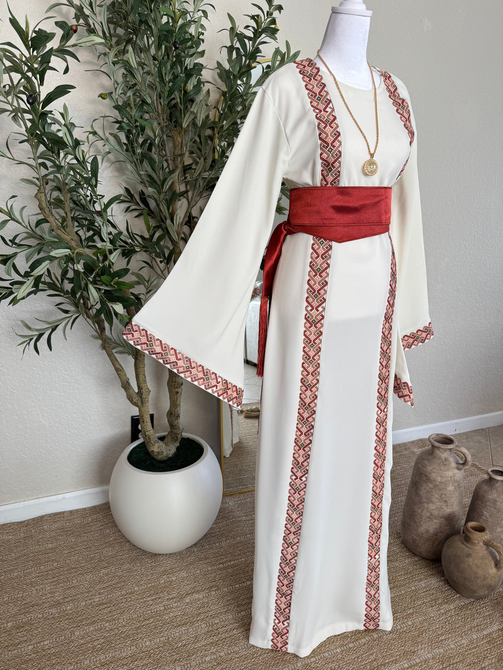 Palestinian inspired modest fashion dress with blush heritage embroidery and flowing silhouette