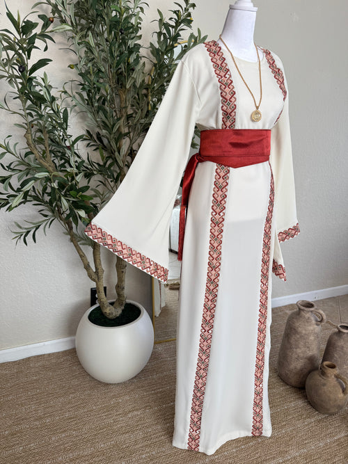 Palestinian inspired modest fashion dress with blush heritage embroidery and flowing silhouette