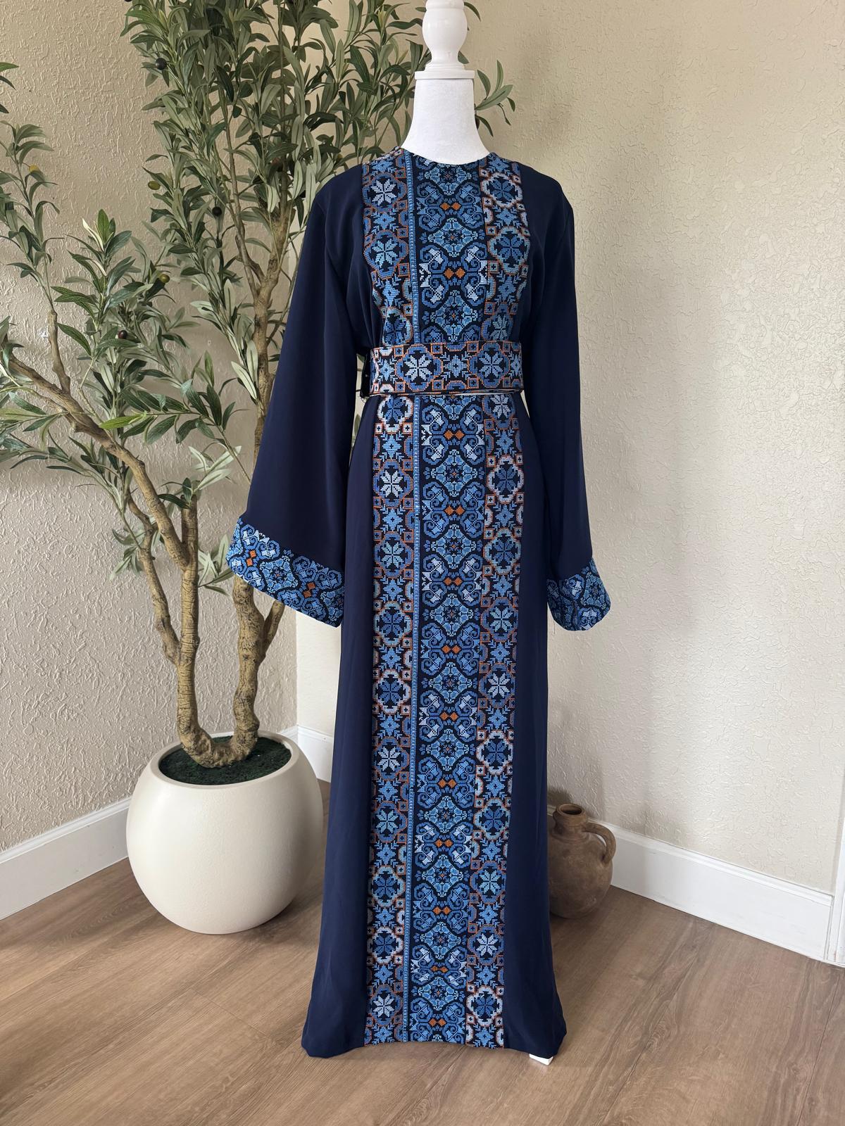 The Cobalt Heritage Thobe in navy with blue geometric front detailing and matching waist belt