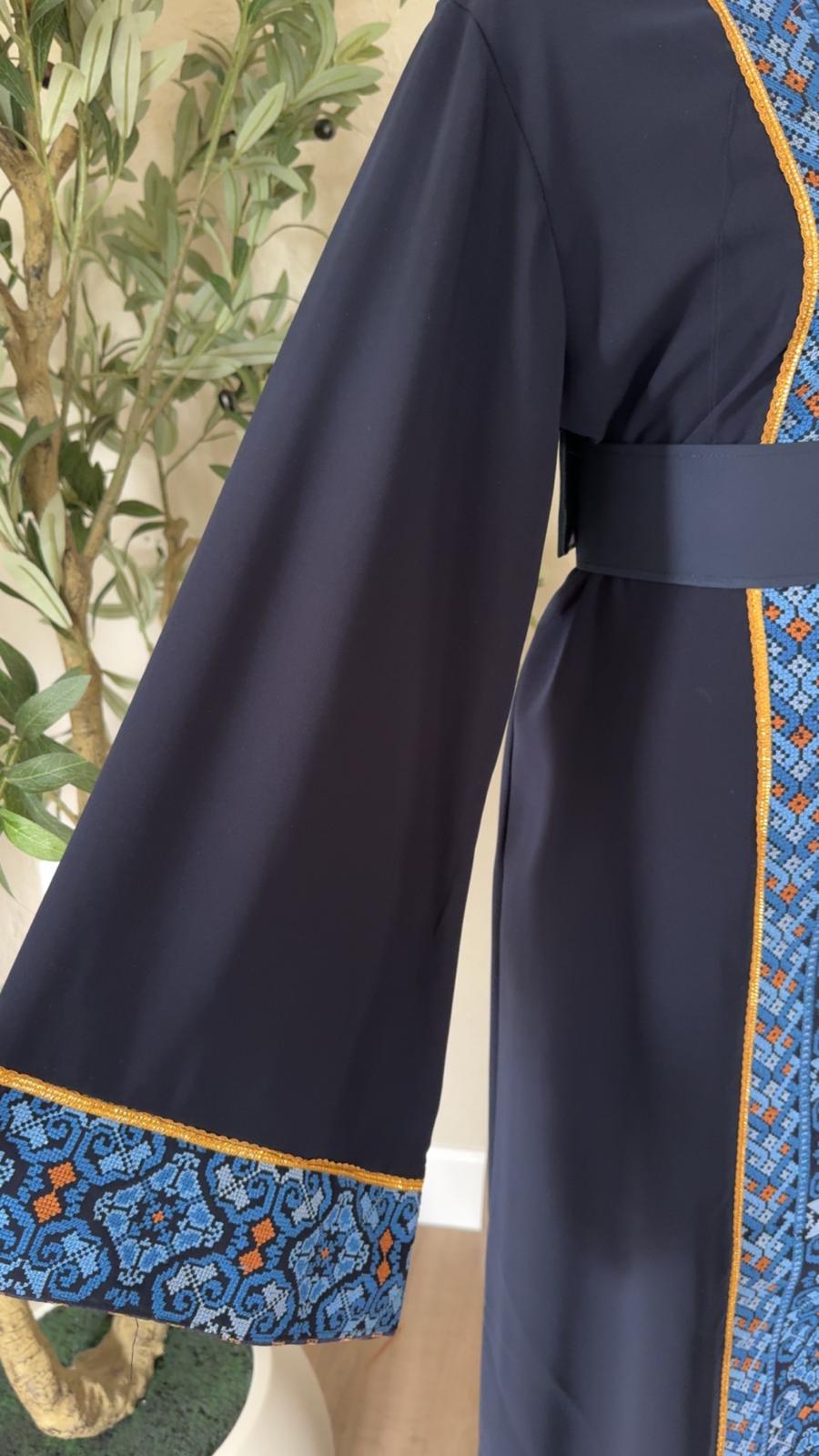 Close-up of The Midnight Mosaic Thobe with blue patterned cuff and gold-toned trim