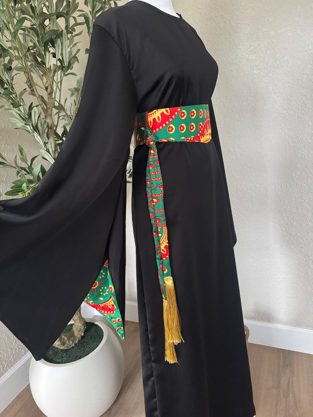 Side view of The Saffron Sash Dress with patterned sash and golden tassel accents