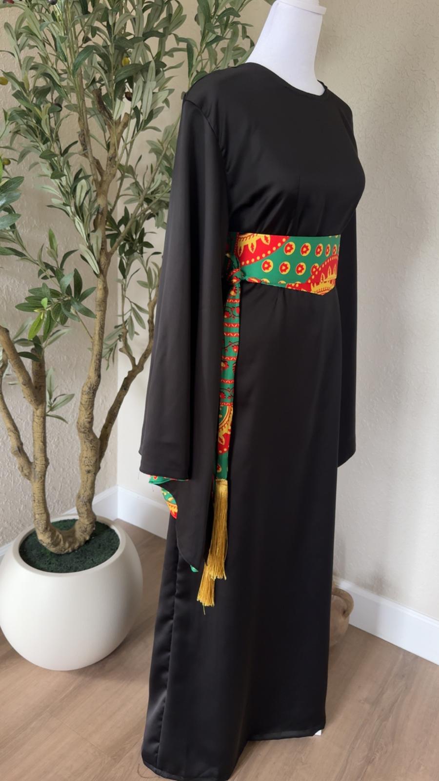 Wide sleeve detail of The Saffron Sash Dress with green patterned lining and golden tassels