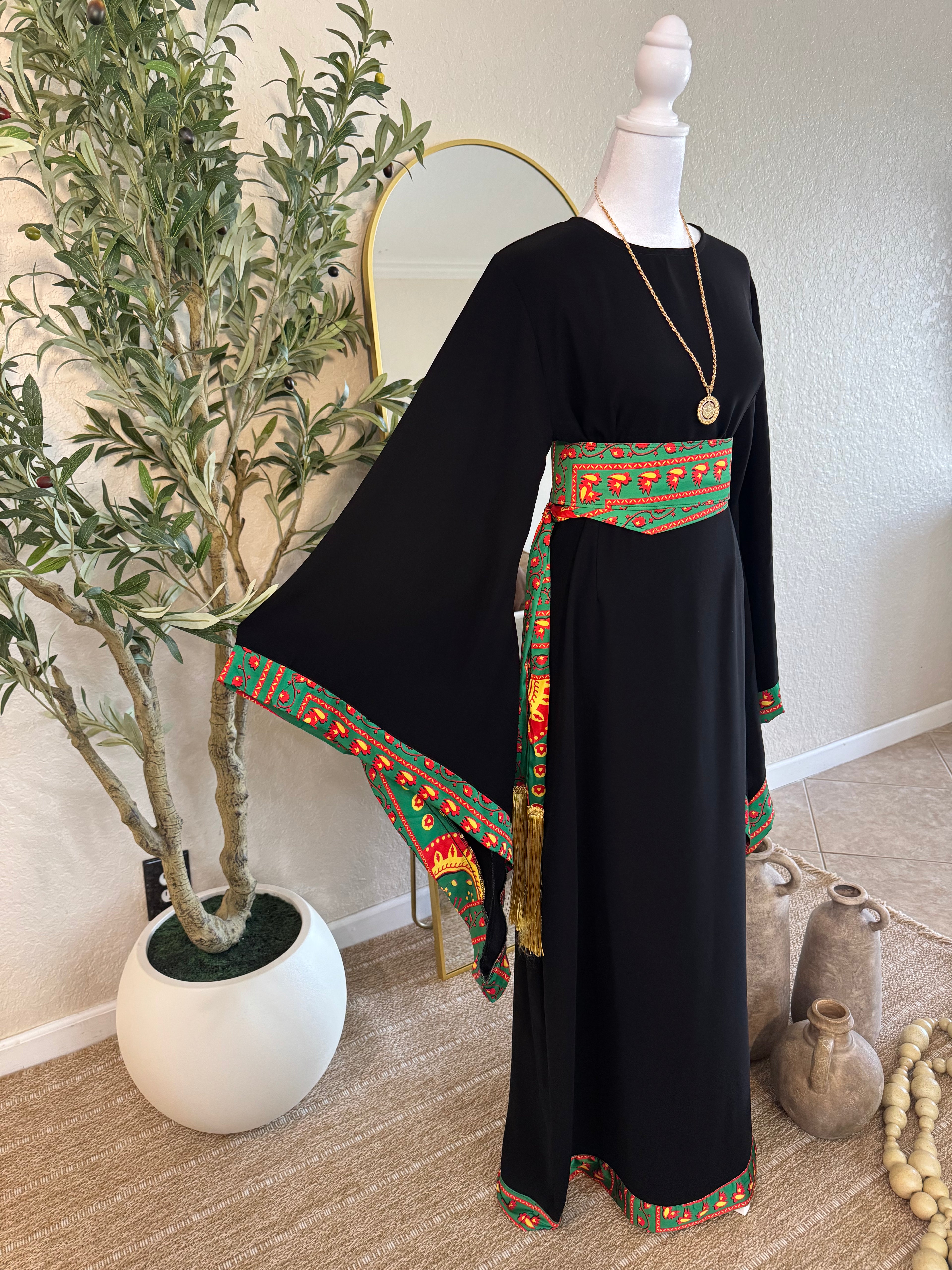 Black traditional Asba abaya with green and red embroidered trim and matching belt